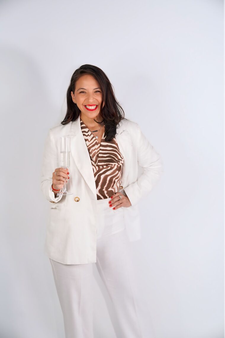 Mayra Cordero raising a glass to celebrate a client's successful home closing